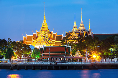 View of the illuminated Grand Palace from the Meridian cruise ship