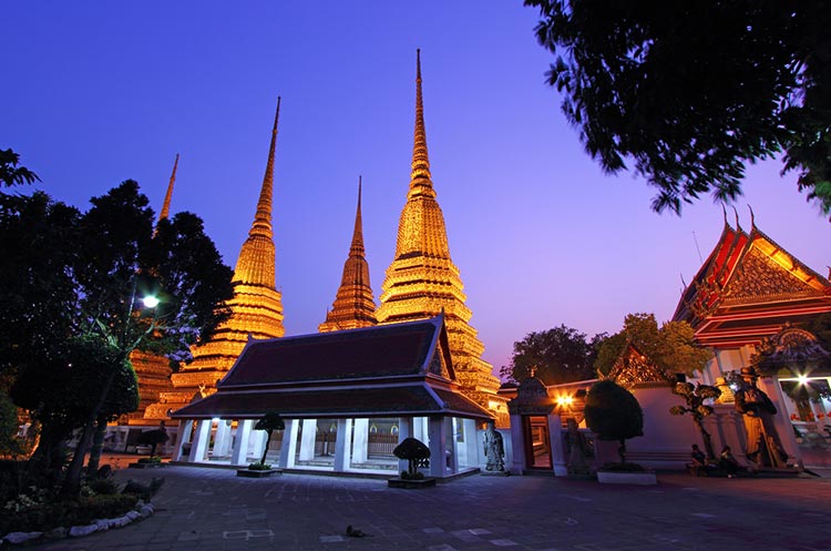 Several chedis at the Wat Pho at dusk