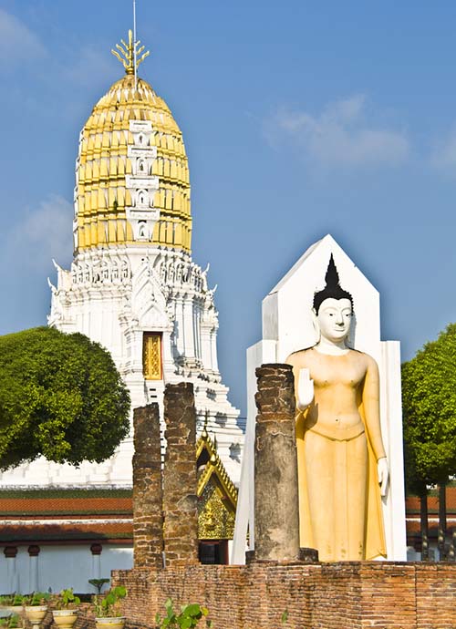 Standing Buddha image in front of an Ayutthaya style prang at Wat Phra Si Rattana Mahathat