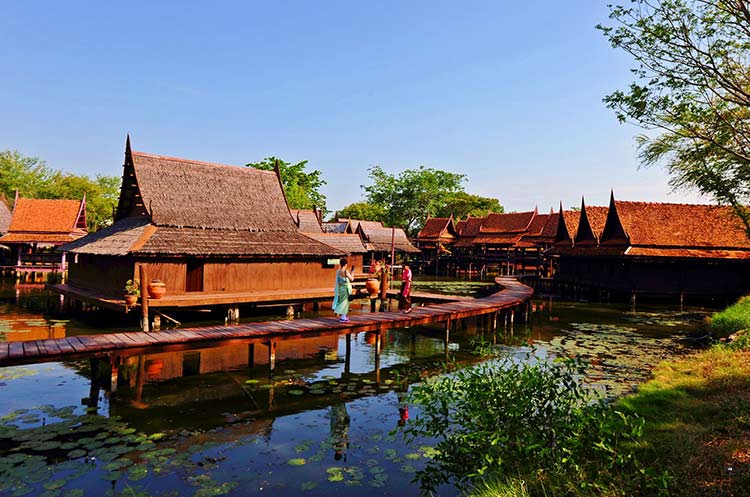 Traditional wooden Thai houses standing on stilts in the water