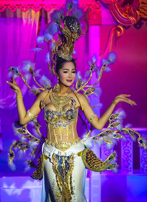An elegant dancer wearing an extravagant dress at Aphrodite cabaret show Phuket