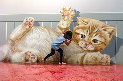 Playing with a giant cat at Art in Paradise Bangkok