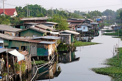 Wooden houses on stilts in one of the Bangkok canals, known in Thai as khlongs