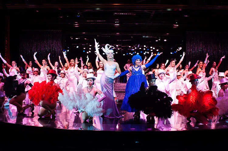 Dancers wearing flashy outfits performing a glitz and glamour Las Vegas style show at Calypso Cabaret