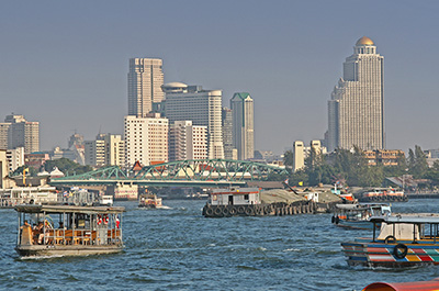 Passenger ferries and cargo ships on the Chao Phraya river in Bangkok
