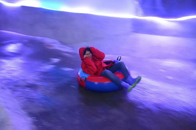 Sliding down the snow in a tube in the Snow Dome