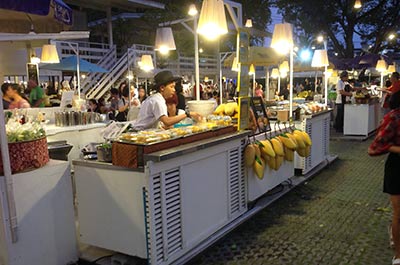 Stalls selling Thai food and fresh fruits at Cicada Market