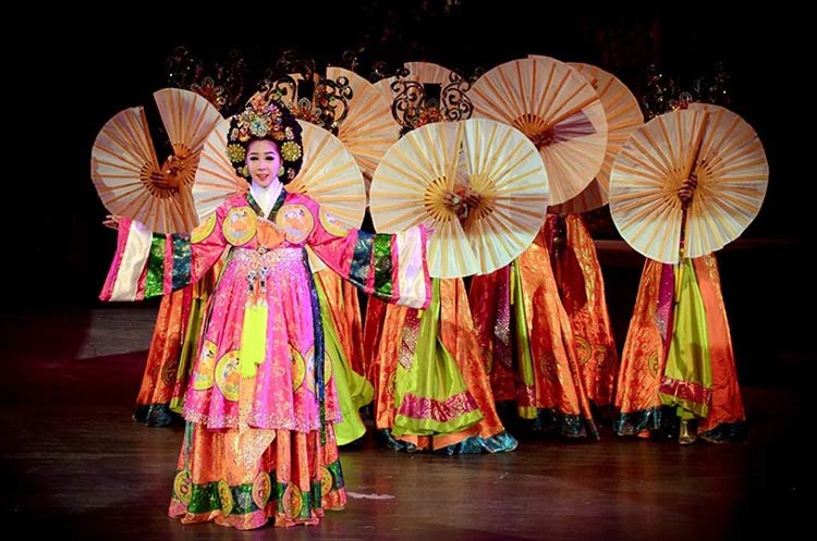 Dancers wearing beautiful gowns performing a Chinese act at the Colosseum Show