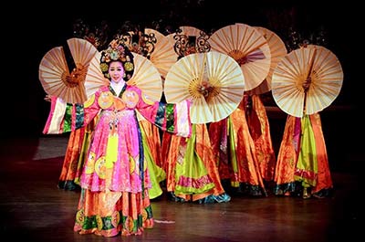 Dancers wearing traditional Chinese dress performing an act on the stage of the Colosseum Cabaret Show