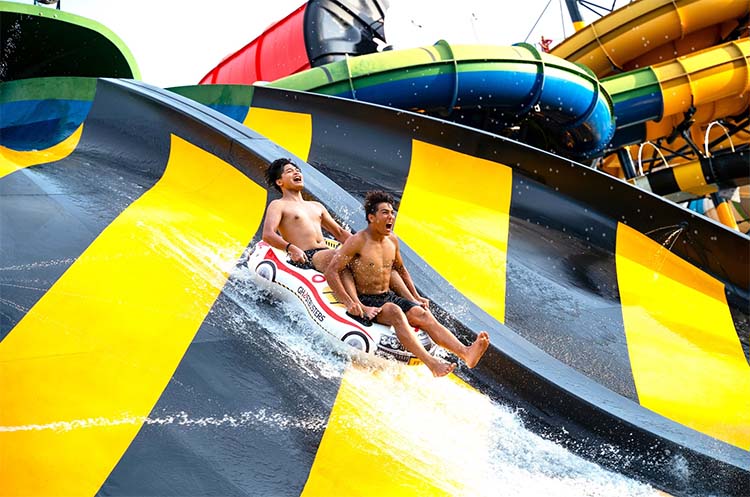 People sliding down a water ride at Columbia Pictures Aquaverse Water Park