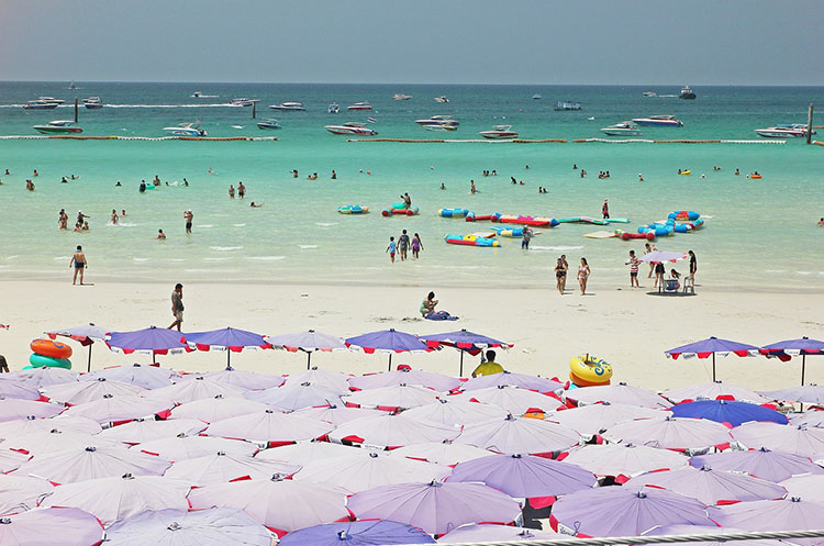 Beach chairs and parasols on a Coral Island beach