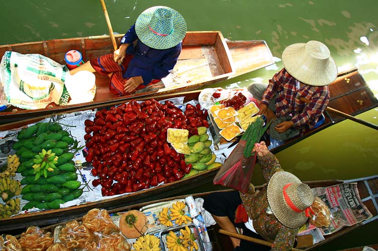 Boats with fresh fruits and vegetables on the canals of the Damnoen Saduak floating market