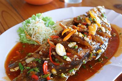 A whole fish cooked with sweet chili sauce