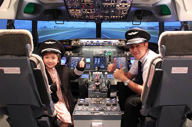 Young aspiring pilot and instructor in the Boeing 737 cockpit of Flight Experience