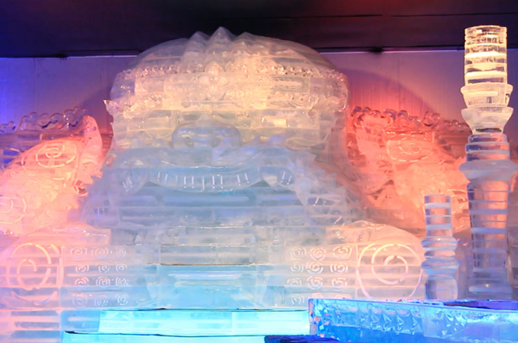 The head of a mythological being carved out of ice