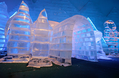 An igloo and sculpted eskimos and penguins at Frost Magical Ice