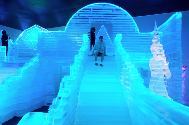 Sliding down an icy slide at Frost Magical Ice of Siam