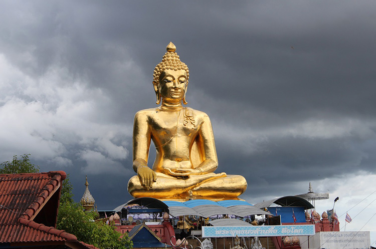 The golden Buddha seated in a boat at the Golden Triangle Park