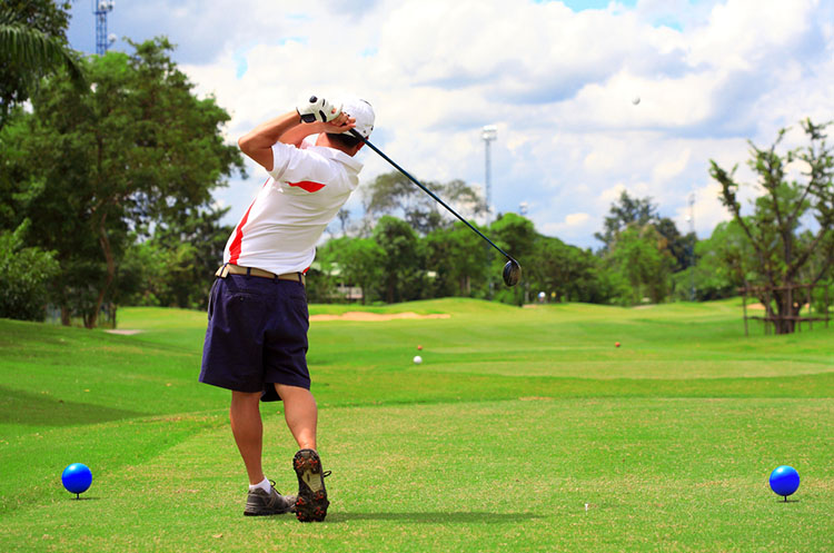 Playing golf on a tropical course in Thailand