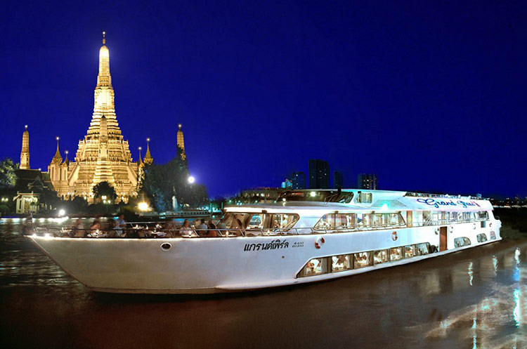 The Grand Pearl dinner cruise ship floating by Wat Arun temple on the Chao Phraya river