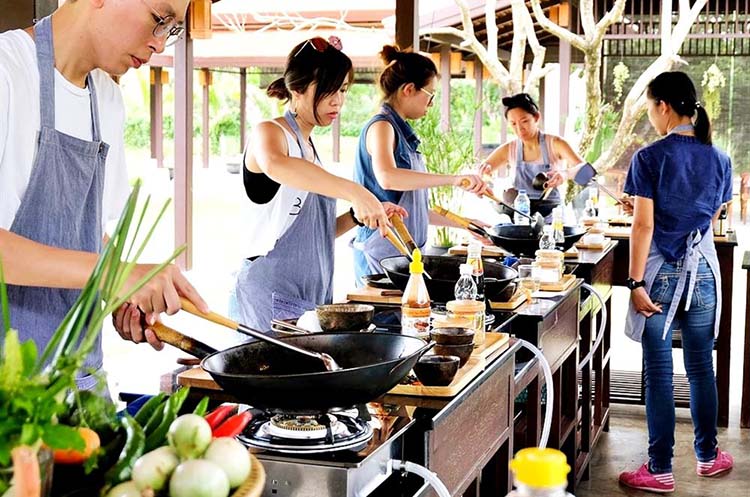 Students cooking Thai food at Grandma’s Home Cooking School