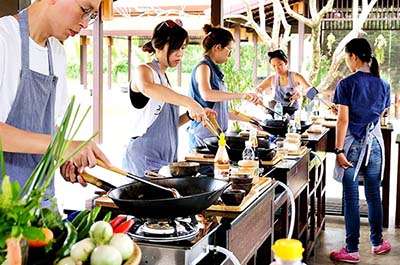 Students learning how to cook Thai food at Grandma’s Home Cooking School