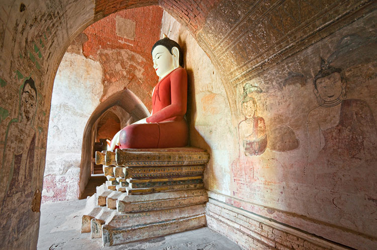 Buddha image seated on a pedestal in the Htilominlo temple