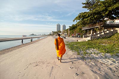 A monk walking down the beach in Hua Hin