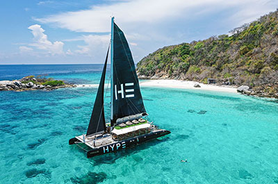 The catamaran of the Hype Boat Club floating on the crystal clear waters of the Andaman Sea