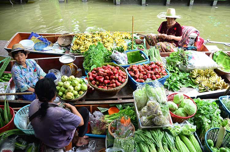 Vendors selling fresh fruits and vegetables from their boats