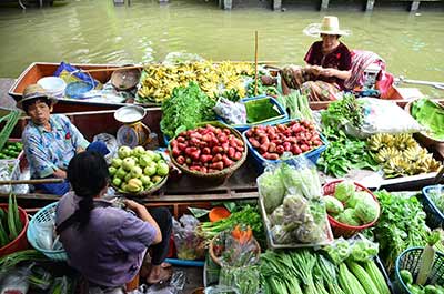 Three boats loaded with fresh produce for sale