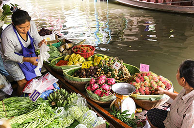 Women selling fresh vegetables and fruits from their boats at Khlong Lat Mayom floating market