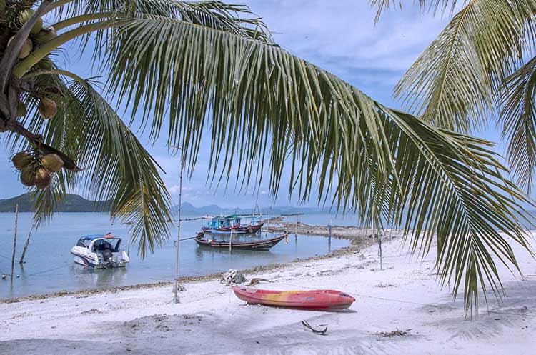 A sandy beach with a fishing boat on Koh Samui