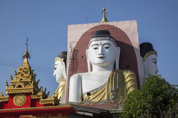 One of the four towering images of the Buddha at the Kyaik Pun pagoda in Bago