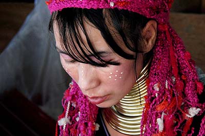 A longneck hill tribe woman wearing brass rings around the neck