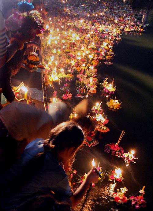 Thousands of krathongs floating down the river