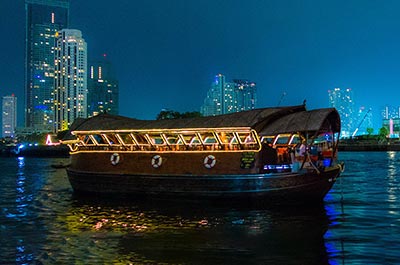 The Loy Nava dinner cruise barge on the river at dusk