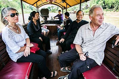 People enjoying the river scenery aboard the Mae Ping river cruise