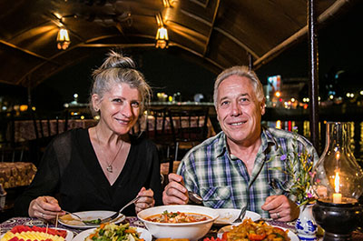 Two people enjoying a Thai dinner aboard the Mae Ping river cruise boat