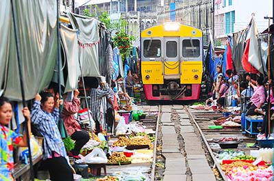 A train arriving at Maeklong Railway Market