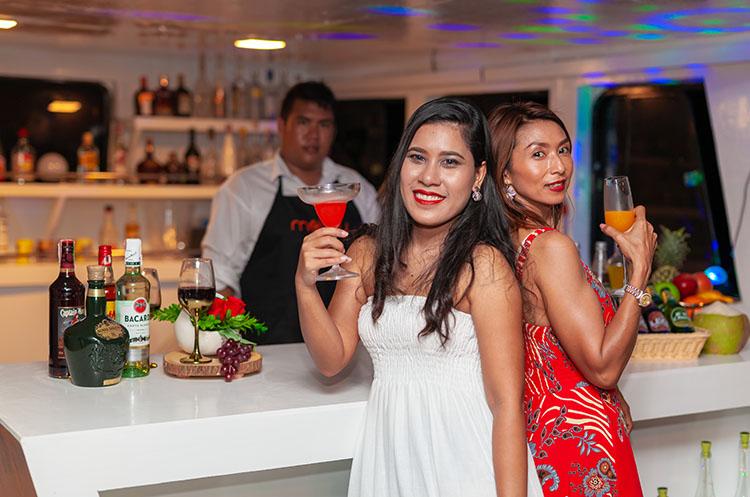 Two women enjoying a drink at the bar