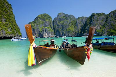 Several longtail boats anchored in Maya Bay on the Phi Phi Islands
