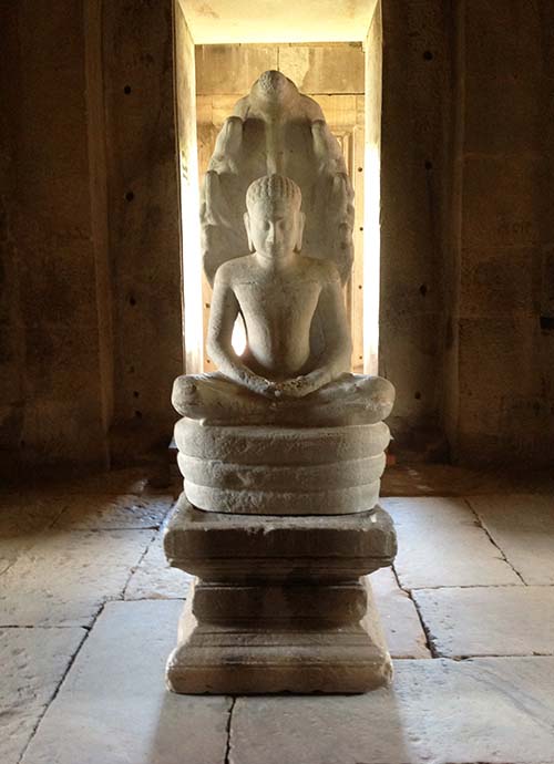 A Buddha image inside a prasat