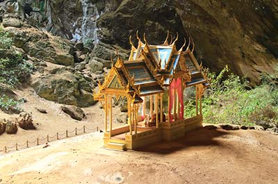 Kuha Karuhas pavilion lit up by the sun shining through an opening in the cave