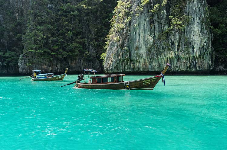 Two boats on the emerald green waters of Pi Leh Lagoon