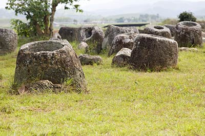 A number of large stone jars scattered on the Plain of Jars near Phonsavan, Laos