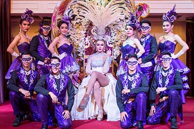 Dancers wearing flashy dresses, glittering gowns with lots of spangle and feathers at one of the ladyboy cabaret shows in Bangkok