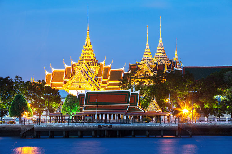 View of the brightly illuminated Grand Palace from the Meridian ship