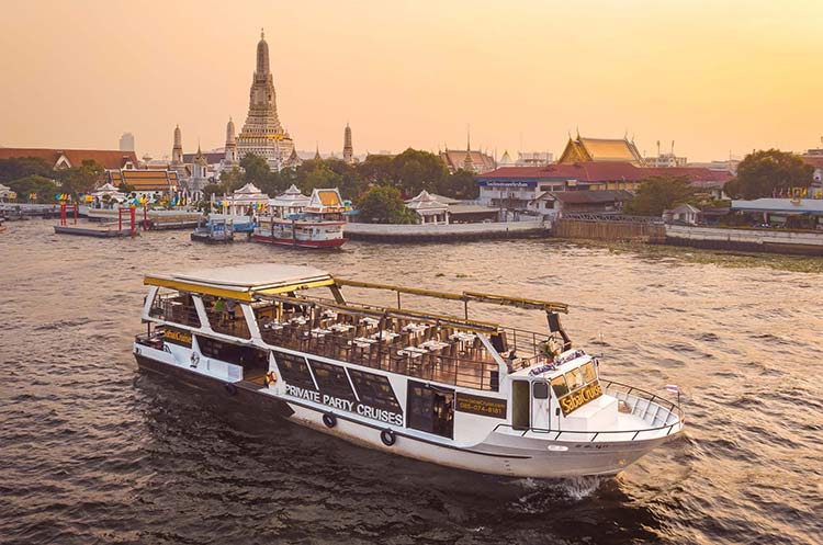 Sabai dinner cruise boat floating past Wat Arun on the Chao Phraya river