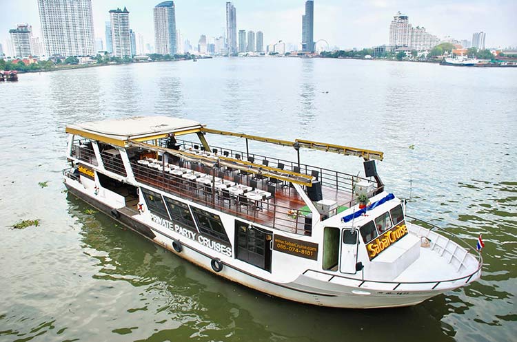 Sabai dinner cruise boat on the river with Bangkok skyline in the background